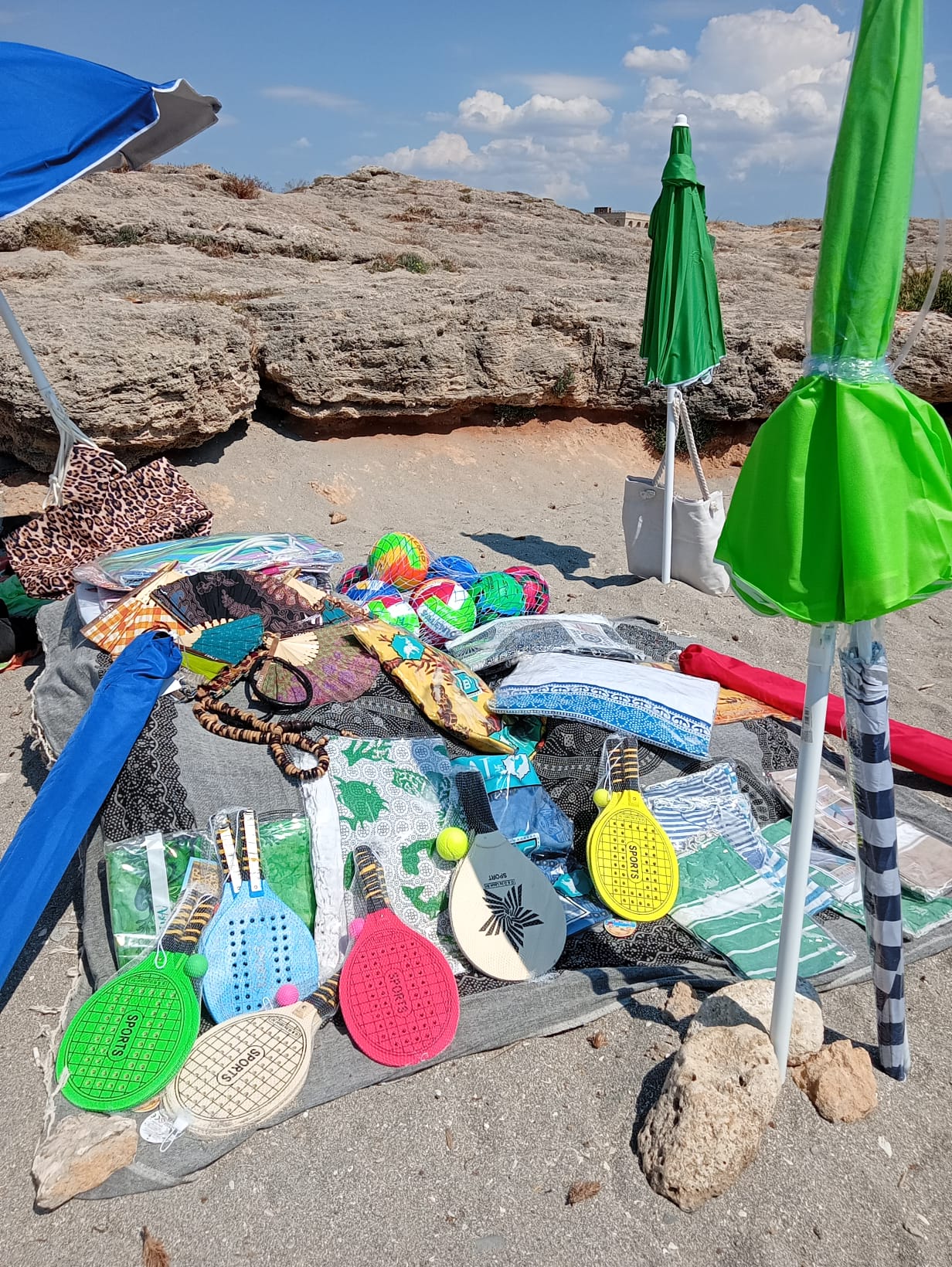 Beach umbrellas, sunbeds, towels, inflatables and beach games sold by Aziz in Gallipoli